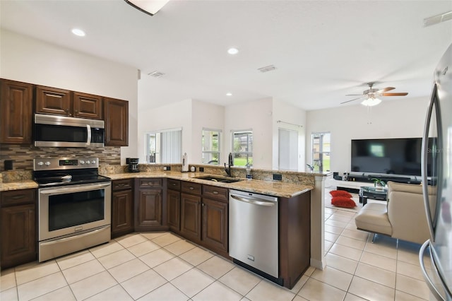 kitchen featuring light tile patterned flooring, visible vents, appliances with stainless steel finishes, and a sink