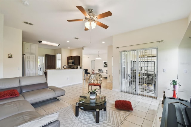 living area featuring visible vents, ceiling fan, baseboards, light tile patterned floors, and recessed lighting