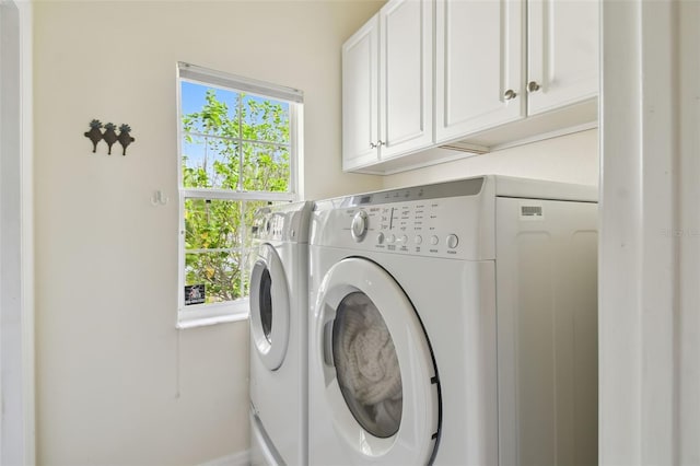 washroom with washer and dryer and cabinet space