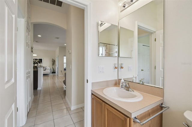 bathroom featuring vanity, baseboards, visible vents, tile patterned flooring, and toilet