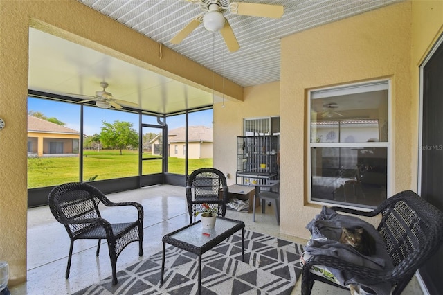 sunroom / solarium with beamed ceiling and ceiling fan