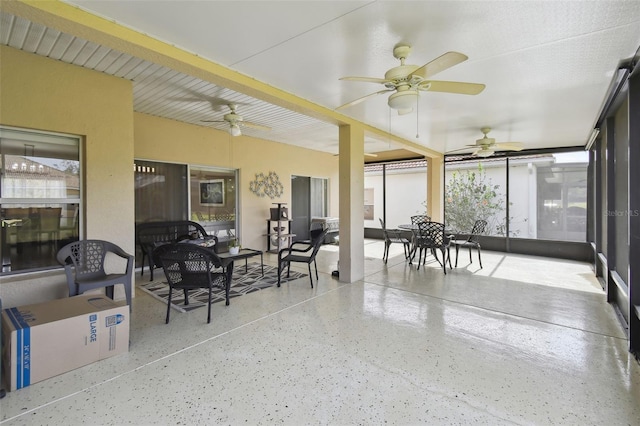 sunroom with plenty of natural light and a ceiling fan