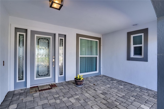 doorway to property with stucco siding