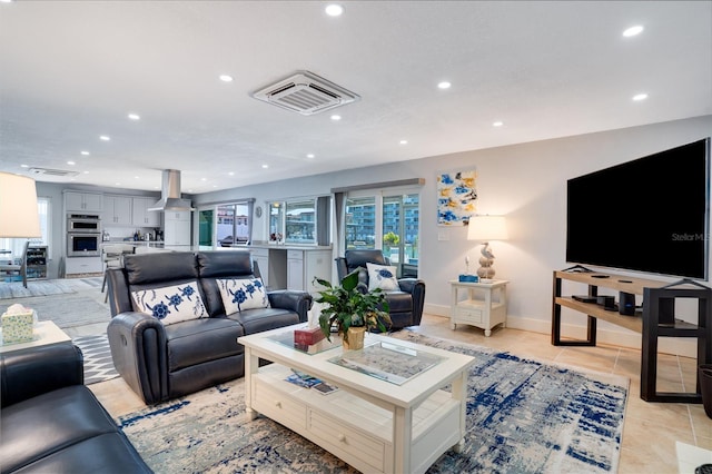 living room with light tile patterned floors, visible vents, recessed lighting, and baseboards