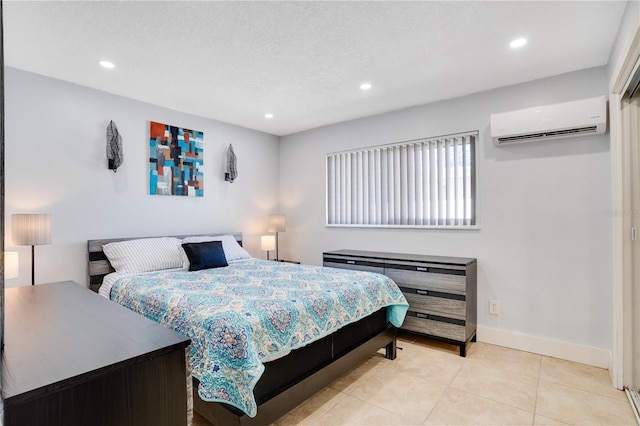 bedroom featuring light tile patterned flooring, recessed lighting, baseboards, and a wall unit AC