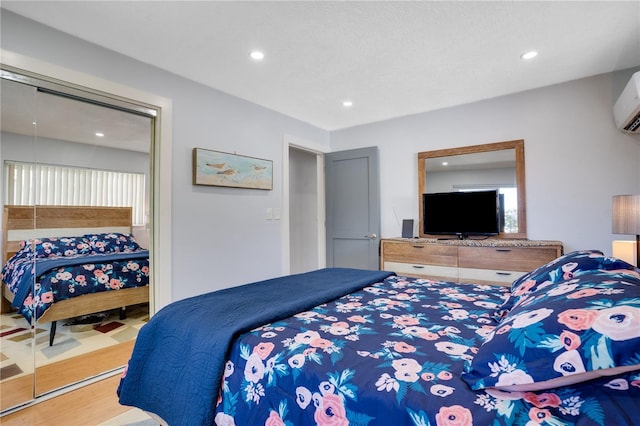 bedroom featuring recessed lighting and a wall mounted air conditioner