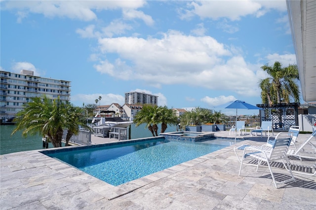 view of swimming pool featuring a patio and a pool with connected hot tub