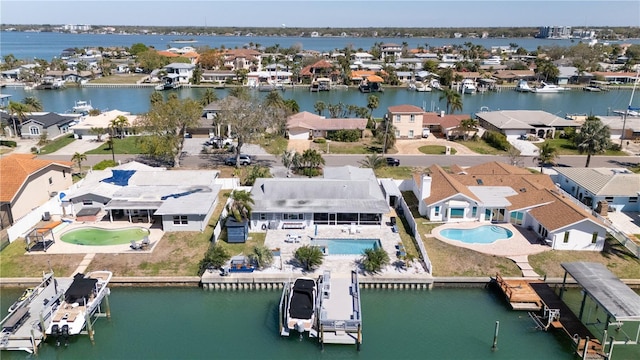 drone / aerial view featuring a residential view and a water view