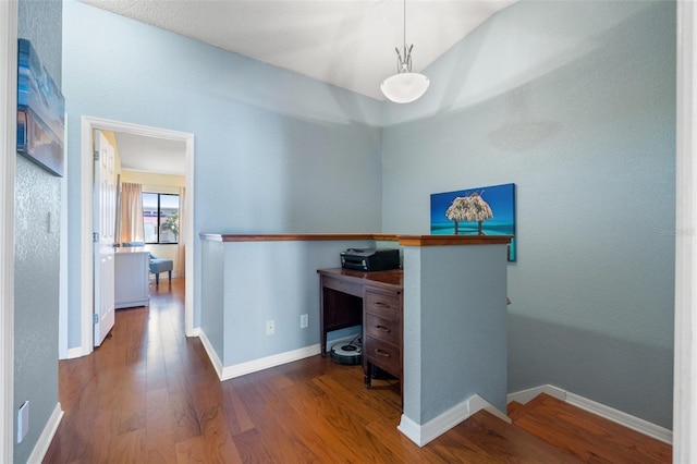 office space with wood finished floors and baseboards