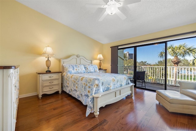 bedroom with ceiling fan, a textured ceiling, wood finished floors, lofted ceiling, and access to exterior