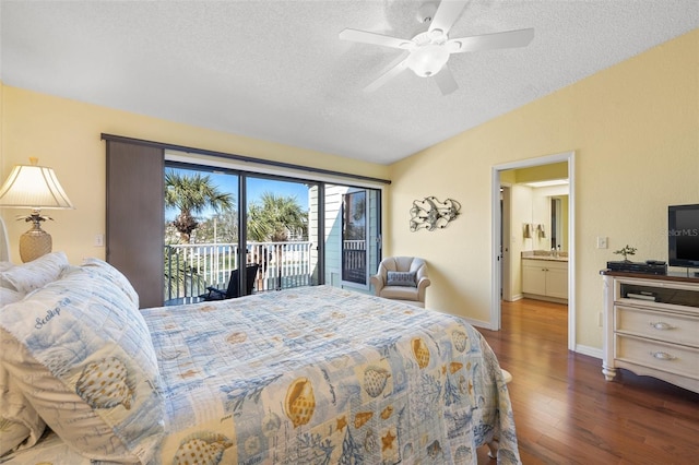 bedroom with baseboards, vaulted ceiling, wood finished floors, a textured ceiling, and access to outside