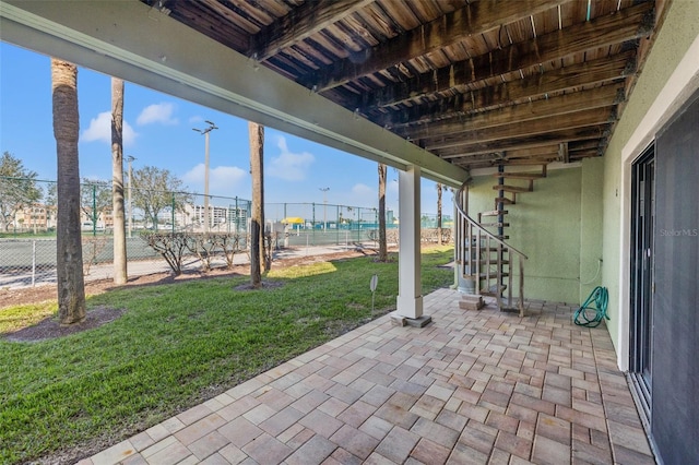 view of patio / terrace with stairway and fence