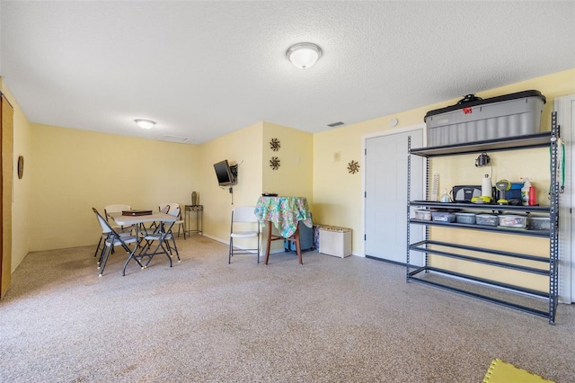 dining space featuring visible vents and a textured ceiling