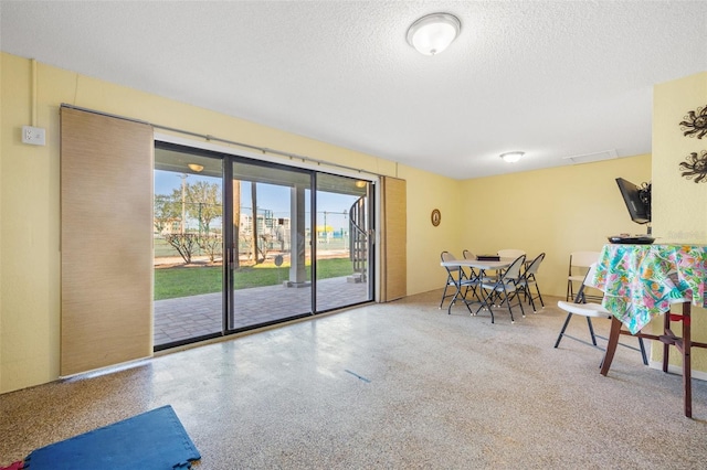 dining room with visible vents, a textured ceiling, and speckled floor