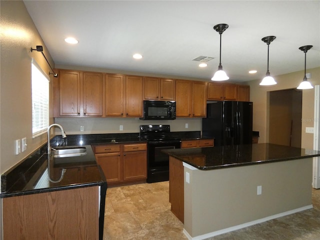 kitchen with brown cabinetry, visible vents, black appliances, and a sink