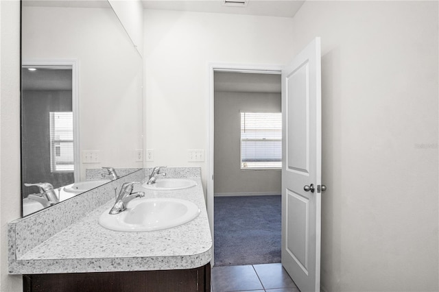 full bath with tile patterned floors, a sink, and double vanity