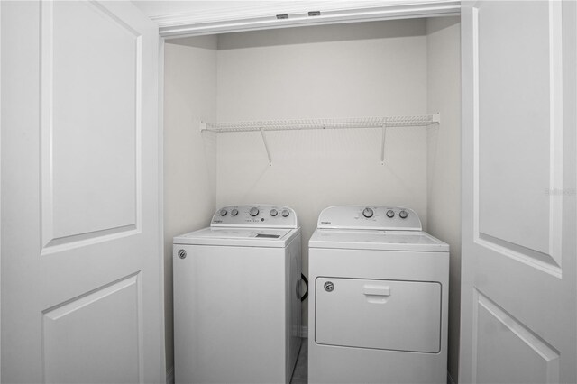 washroom featuring washing machine and clothes dryer and laundry area
