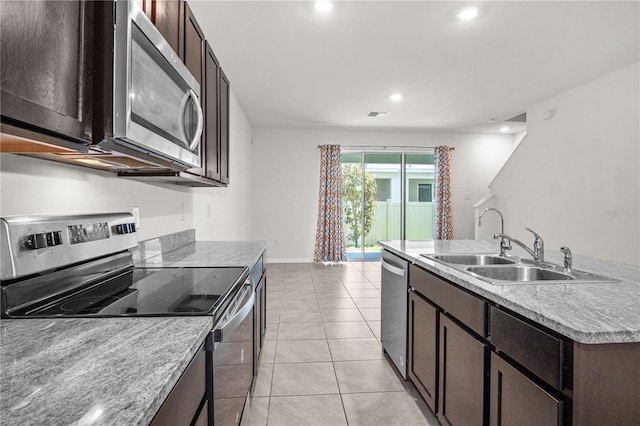 kitchen featuring light countertops, visible vents, a sink, dark brown cabinetry, and appliances with stainless steel finishes