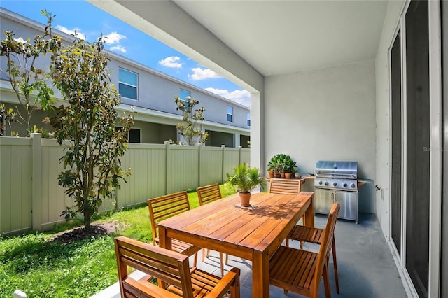 balcony with outdoor dining area and area for grilling