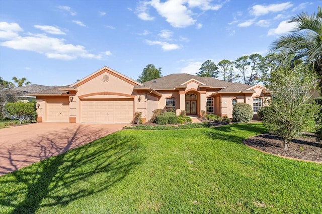 view of front of property with stucco siding, driveway, a garage, and a front yard