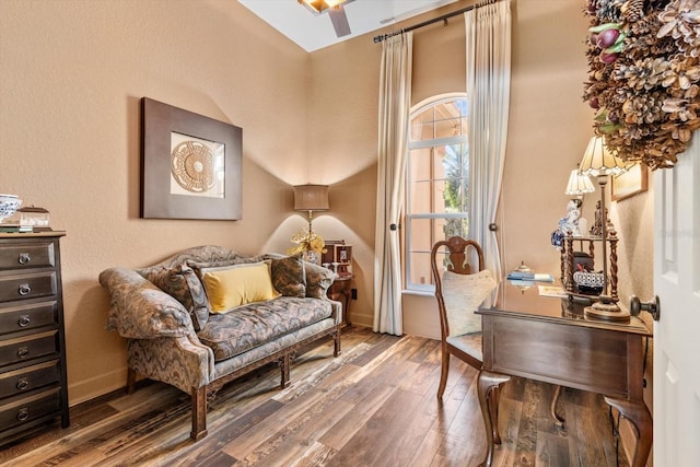 living area with wood finished floors and baseboards