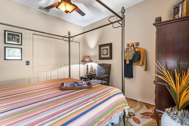 bedroom with visible vents, baseboards, and ceiling fan