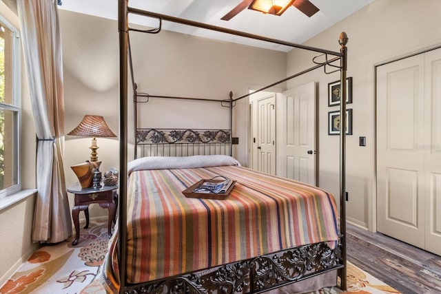 bedroom featuring ceiling fan, a closet, baseboards, and wood finished floors