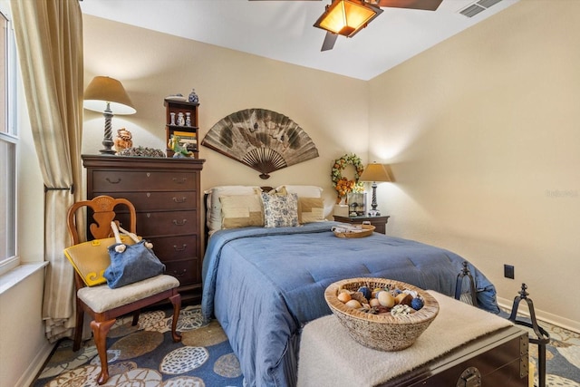 bedroom with visible vents, ceiling fan, and baseboards