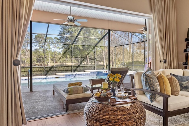 sunroom featuring plenty of natural light and a ceiling fan