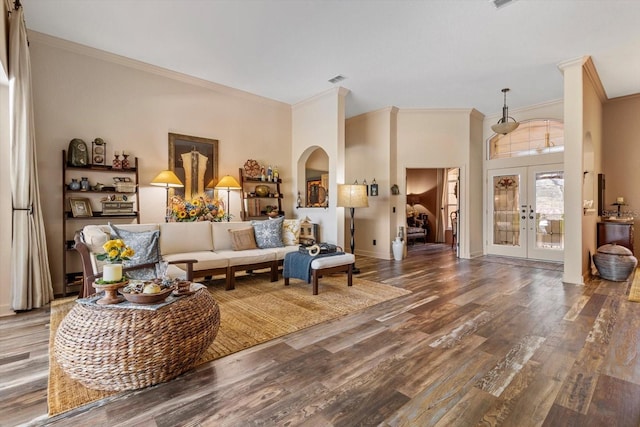 living room with crown molding, baseboards, french doors, wood finished floors, and arched walkways