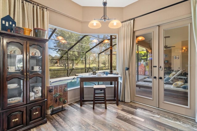 office space with french doors, wood finished floors, and a sunroom