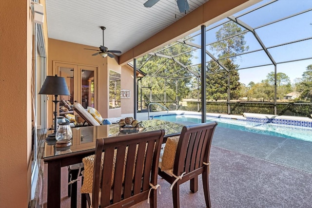 view of patio / terrace featuring a lanai, an outdoor pool, and a ceiling fan