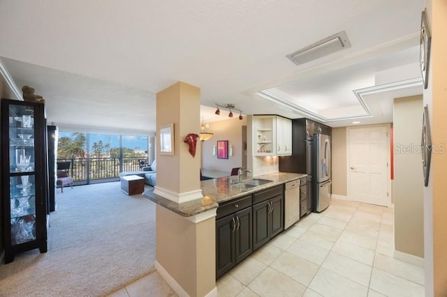 5700 Escondida Blvd S Unit 506, Saint Petersburg, FL 33715 - kitchen featuring visible vents, light stone countertops, a sink, dishwashing machine, and freestanding refrigerator