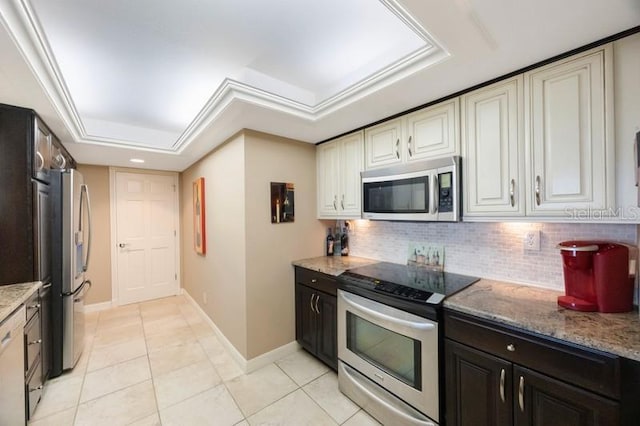 5700 Escondida Blvd S Unit 506, Saint Petersburg, FL 33715 - kitchen featuring light tile patterned floors, stainless steel appliances, baseboards, backsplash, and light stone countertops