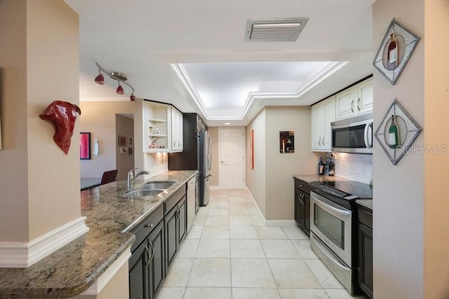 5700 Escondida Blvd S Unit 506, Saint Petersburg, FL 33715 - kitchen with visible vents, light stone countertops, appliances with stainless steel finishes, a sink, and a tray ceiling