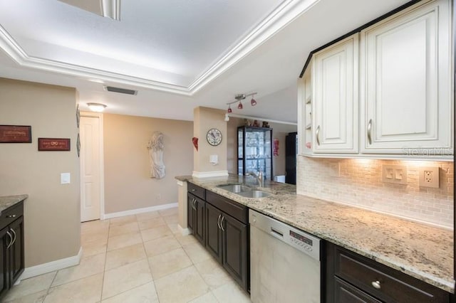 5700 Escondida Blvd S Unit 506, Saint Petersburg, FL 33715 - kitchen with white cabinetry, tasteful backsplash, stainless steel dishwasher, a raised ceiling, and a sink