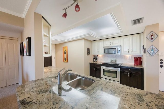 5700 Escondida Blvd S Unit 506, Saint Petersburg, FL 33715 - kitchen with light stone counters, a sink, tasteful backsplash, appliances with stainless steel finishes, and visible vents