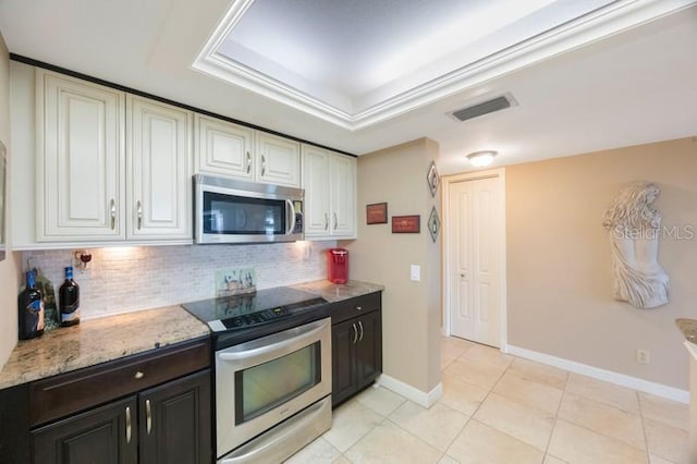 5700 Escondida Blvd S Unit 506, Saint Petersburg, FL 33715 - kitchen with tasteful backsplash, light stone countertops, stainless steel appliances, visible vents, and white cabinets