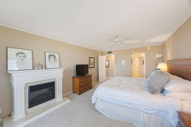 5700 Escondida Blvd S Unit 506, Saint Petersburg, FL 33715 - bedroom with light carpet, visible vents, ceiling fan, and a glass covered fireplace