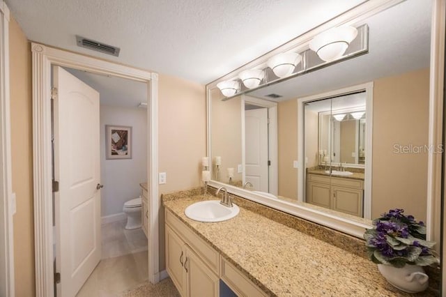 5700 Escondida Blvd S Unit 506, Saint Petersburg, FL 33715 - full bathroom with vanity, toilet, baseboards, a textured ceiling, and visible vents