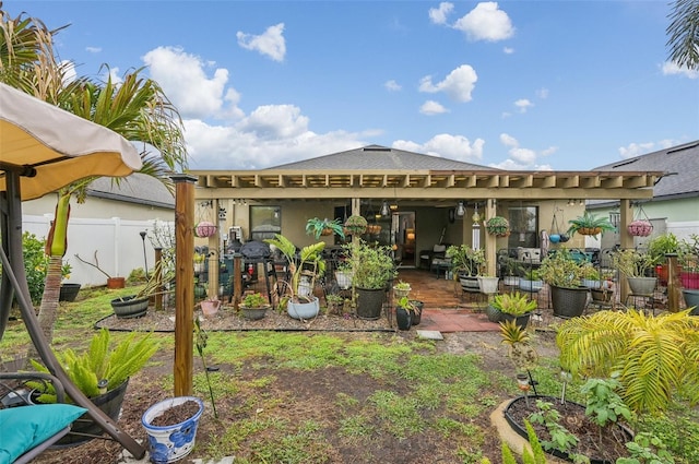 rear view of house with a patio and fence