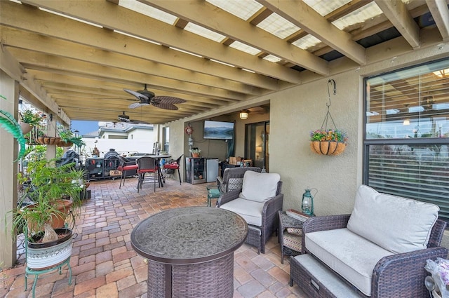 view of patio with outdoor dining space, an outdoor hangout area, and a ceiling fan