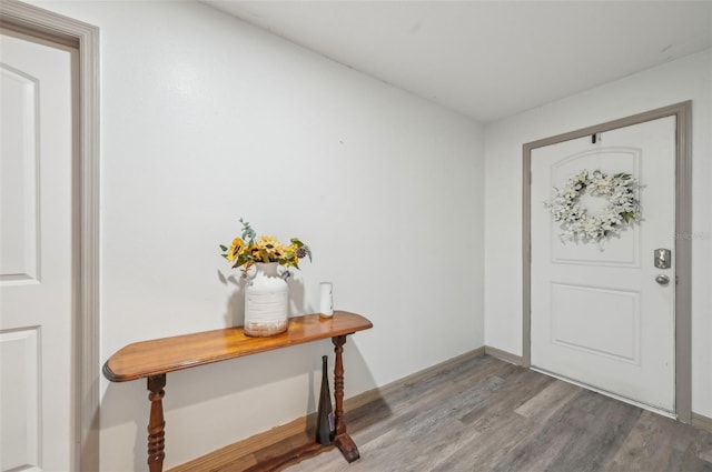 entryway featuring baseboards and wood finished floors