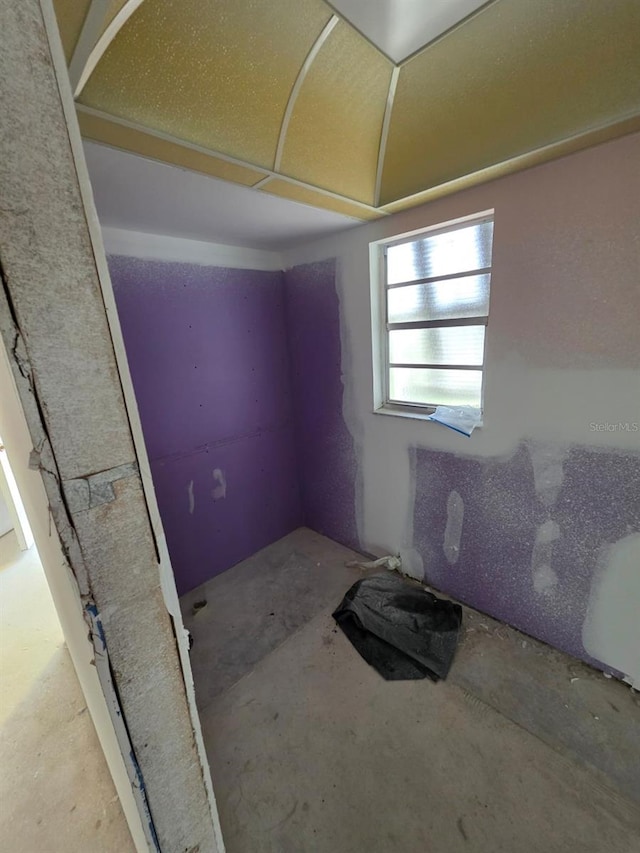 unfurnished room featuring unfinished concrete flooring