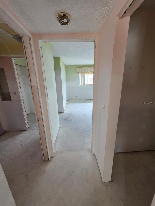 hallway featuring a textured ceiling