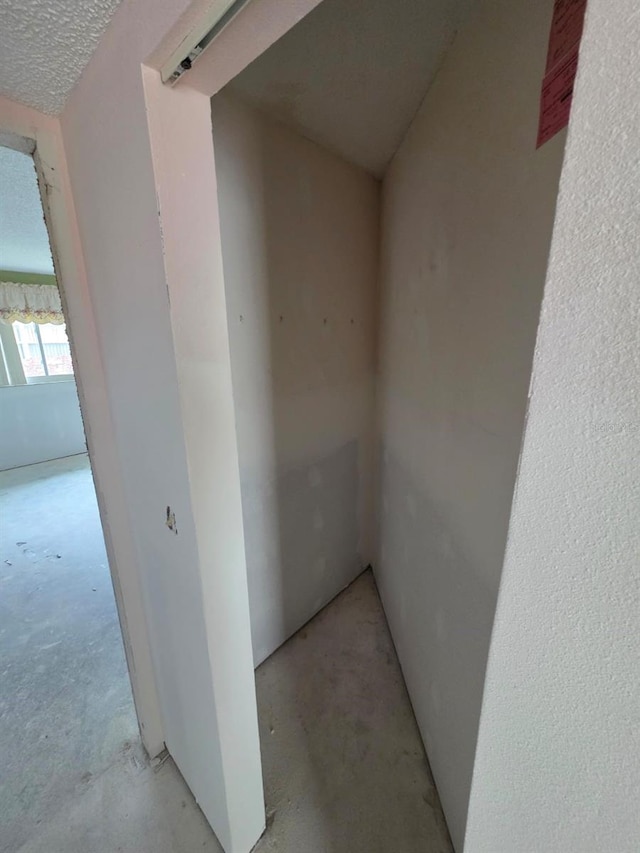 hallway with concrete flooring