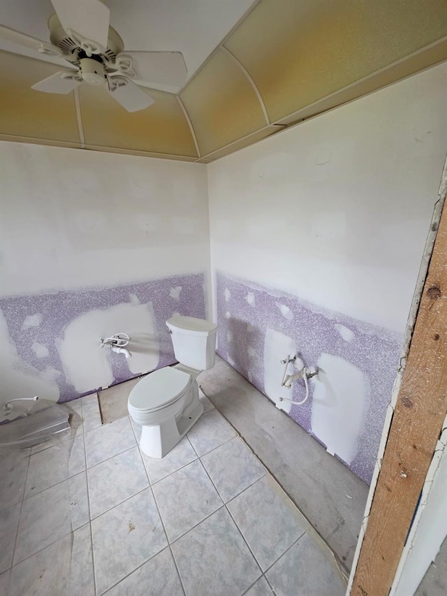 bathroom featuring tile patterned flooring, toilet, and ceiling fan