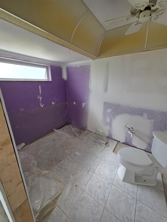 bathroom featuring tile patterned floors, toilet, and a ceiling fan