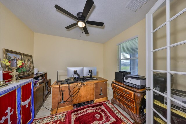 office area featuring visible vents, a textured ceiling, wood finished floors, and a ceiling fan