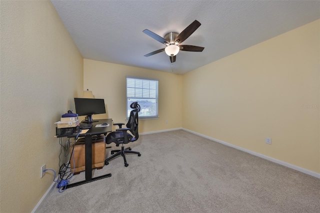 carpeted office with ceiling fan, a textured ceiling, and baseboards